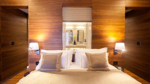a bedroom with a large bed with wooden walls at La Cigale Tabarka in Tabarka