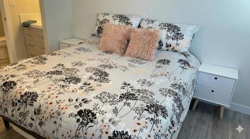a bed with a black and white comforter and two pillows at True Ski-In-Ski-Out Rare 3-Bed Condo in Mount Washington