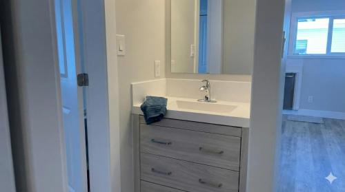 a bathroom with a sink and a mirror at True Ski-In-Ski-Out Rare 3-Bed Condo in Mount Washington