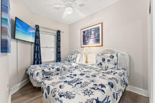 a bedroom with a bed and a ceiling fan at Majestic Resort! Newly Updated Beachfront 3BR Condo in Panama City Beach