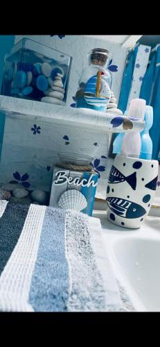 a bathroom counter with a sink with blue and white items at Master private room in shared appartement in Athens