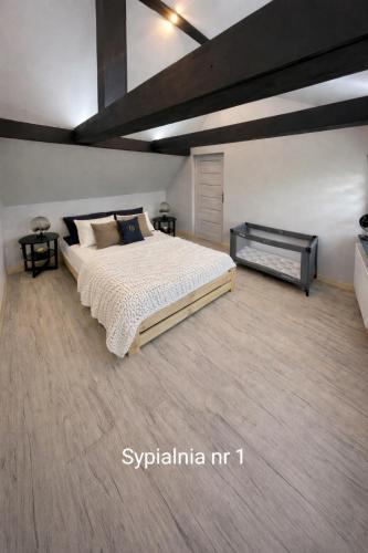 a bedroom with a large bed in a room at Dom u Teresy in Harkabuz