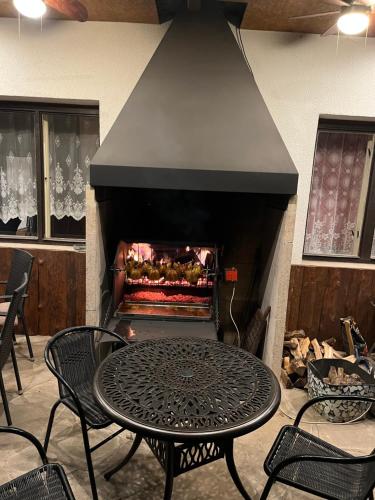 a table and chairs in front of a fireplace at Ubytování u Šveců u Adršpachu in Jívka