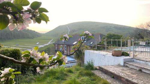 a house with a view of a valley with flowers at Durdle Door Hotel in Lulworth Cove