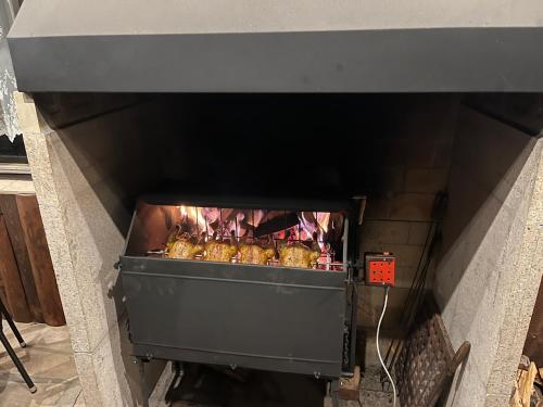 a oven with some food cooking in it at Ubytování u Šveců u Adršpachu in Jívka