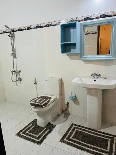 a bathroom with a toilet and a sink at Hikka Magnoon Villa in Hikkaduwa