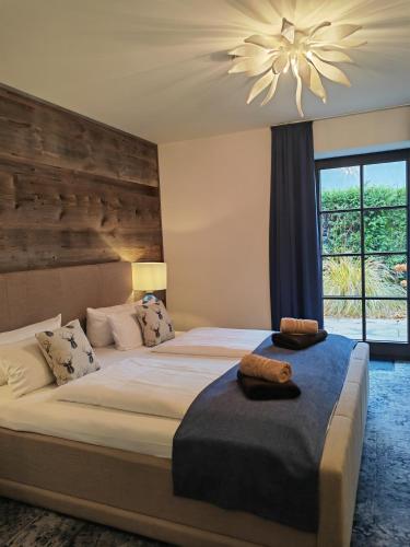 a bedroom with a large bed with a ceiling fan at Pension Kleiner König in Struppen-Siedlung