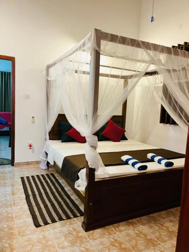 a bedroom with two bunk beds with mosquito nets at Hikka Magnoon Villa in Hikkaduwa