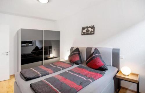 a bedroom with a large bed with two pillows at Ferienhof Broger FeWo Bergblickle mit Pool in Neukirch