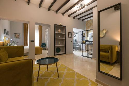 a living room with a couch and a table at Boutique Suites in Arcos de la Frontera