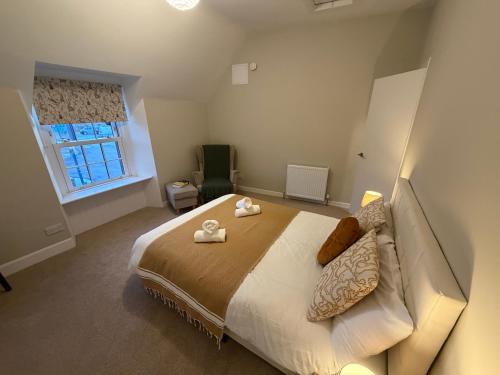 a bedroom with a bed with two towels on it at Roods Apartment in Angus