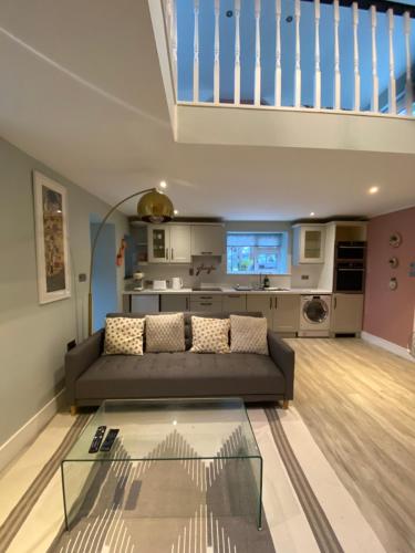 a living room with a couch and a kitchen at Quiet countryside retreat in Cork