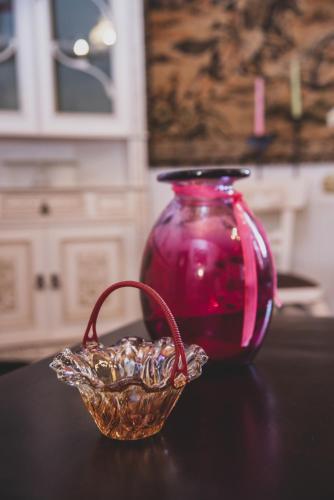 a red vase and a basket on a table at Sea View Traditional Villa in Vourvourou