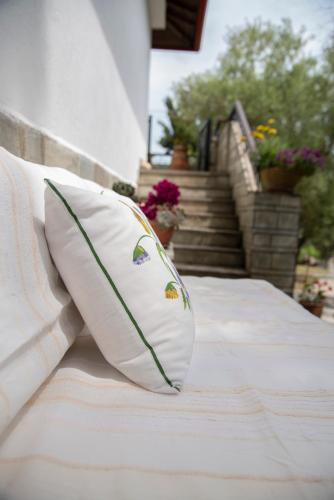 a pillow sitting on top of a bed at Sea View Traditional Villa in Vourvourou
