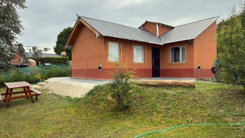 a house with a green hose in front of it at Buena Vista Trevelin II in Trevelín