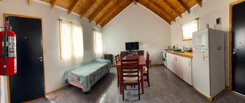 a kitchen with a table and a desk in a room at Buena Vista Trevelin II in Trevelín