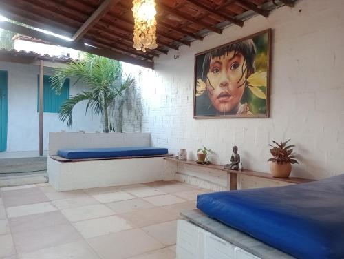 a bedroom with two beds and a painting on the wall at Pousada Infinito Azul in Prea