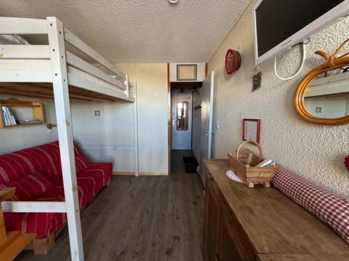 a room with a bunk bed and a living room at Studio La Plagne Villages in La Plagne Tarentaise