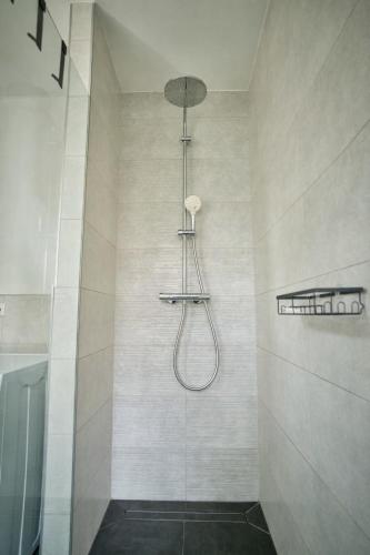 a shower with a shower head in a bathroom at *Premium-Apartment im Spreewald* in Burg