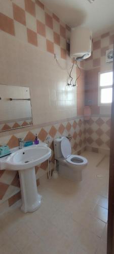 a bathroom with a sink and a toilet at Private Rooms For Rent Near Airport - Raha Hostel in Ḩayl Āl ‘Umayr