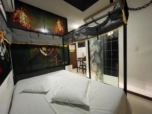 a bedroom with a white bed in a room at Motel Numsei Orla in Aracaju