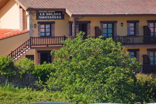 a building with a sign that reads la santa dominica tournament at La Solana Montañesa in Comillas