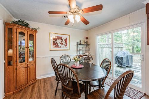 a dining room with a table and chairs and a ceiling fan at Kelly's Comfortable Quinton Home in Quinton