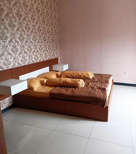 a bedroom with a bed with a dog laying on it at Villa Oentoeng 1 Private Pool 3 Kamar in Punten