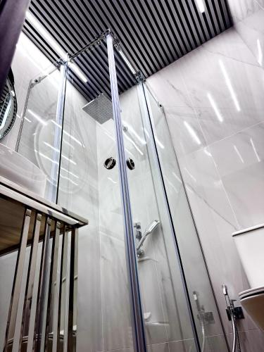 a shower with a glass door in a bathroom at Château Byurakan Hotel in Byurakan