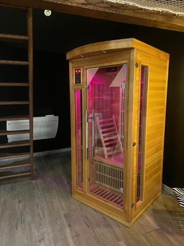 a wooden room with a cage in a bedroom at Eden spa appartement d’exception in Dijon