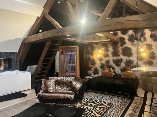 a living room with a bed and a staircase at Eden spa appartement d’exception in Dijon