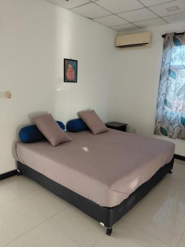a bedroom with a large bed in a room at Lovely beach hotel in Negombo