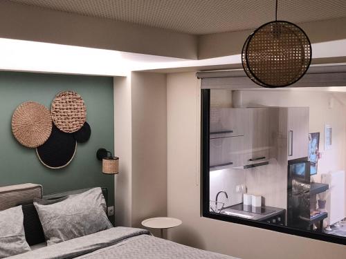 a bedroom with a bed with a mirror and a window at Φεγγαρόπετρα ΓΑΙΟΦΩΣ in Kalívia