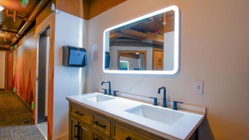 a bathroom with a sink and a mirror at Park City Hostel in Park City