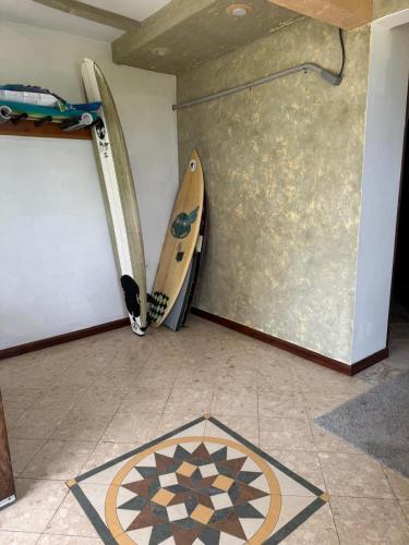two surfboards leaning against a wall in a room at Oceanfront Hideaway mainfloor in Isabela