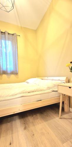 a bed in a room with a window and a desk at Leilighet i Sokndal in Sokndal