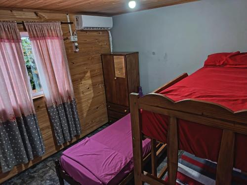 a bedroom with a bed and a window at jazmin apart iguazu in Puerto Iguazú