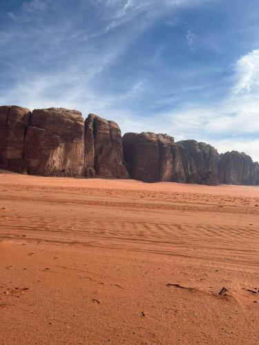 a desert with large rocks in the distance at Wadi rum fun time in Wadi Rum