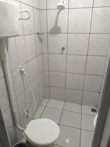 a bathroom with a toilet and a shower at Pousada Ouro branco Mossoró RN in Mossoró