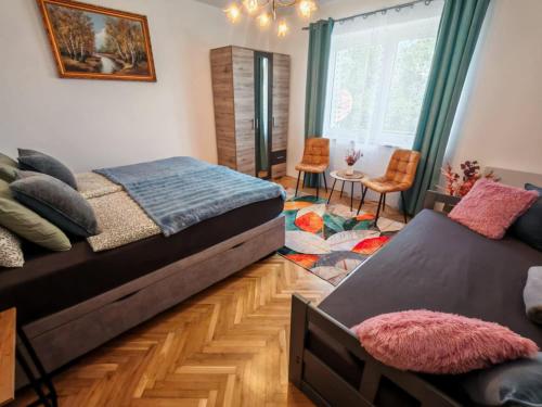 a bedroom with two beds and a table and chairs at Bakonyi Vénkörte Vendégház in Bakonypéterd