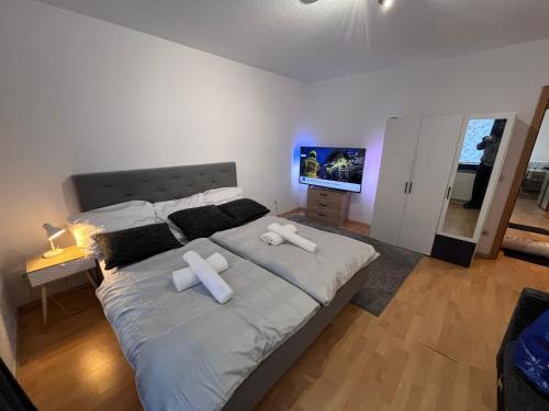 a bedroom with a large bed with two pillows on it at Kenny's place in Essen