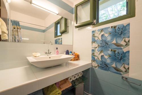 a bathroom with a white bowl sink on a counter at The Captain's View in Aegina
