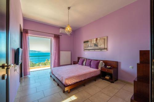a bedroom with a bed and a large window at The Captain's View in Aegina