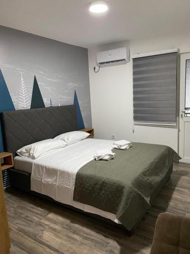 a bedroom with a large bed in a room at Vila Seawolf Apartments in Sutomore