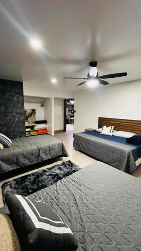 a bedroom with two beds and a ceiling fan at Casa Niagara in San Antonio