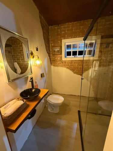 a bathroom with a toilet and a glass shower at Gastehaus Watzko in Piçarras