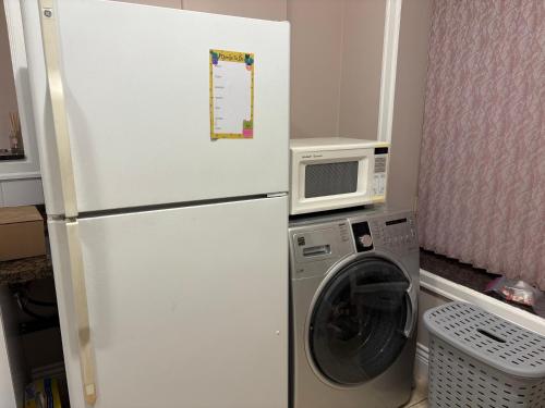 a white refrigerator in a kitchen with a washing machine at Vacation Home in Vancouver