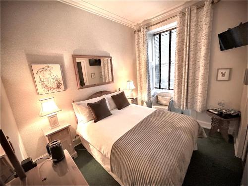 a bedroom with a bed and a window at Rockhill Guest House in Moffat