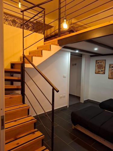 a room with stairs and a bunk bed at Officina dei ricordi in Casagiove