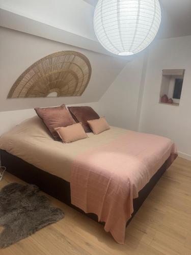 a bedroom with a bed with a fan on it at L atelier du dormeur in Oberhoffen-sur-Moder